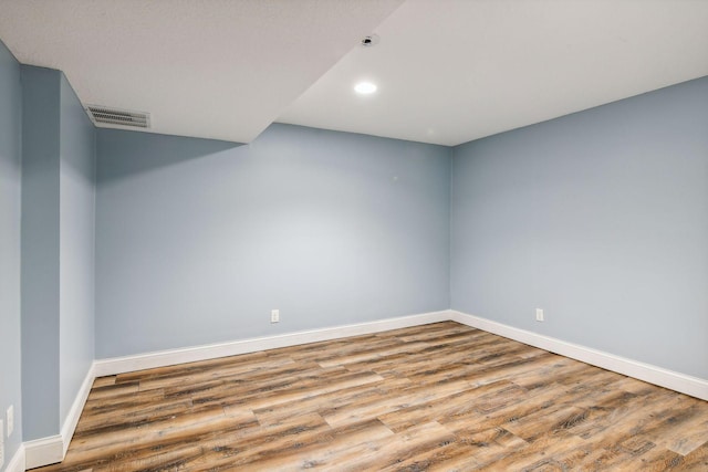 unfurnished room with light wood-type flooring