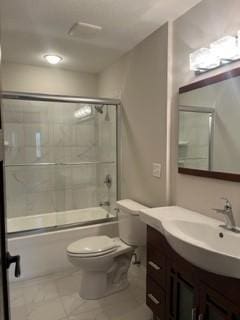 full bathroom featuring vanity, toilet, and bath / shower combo with glass door