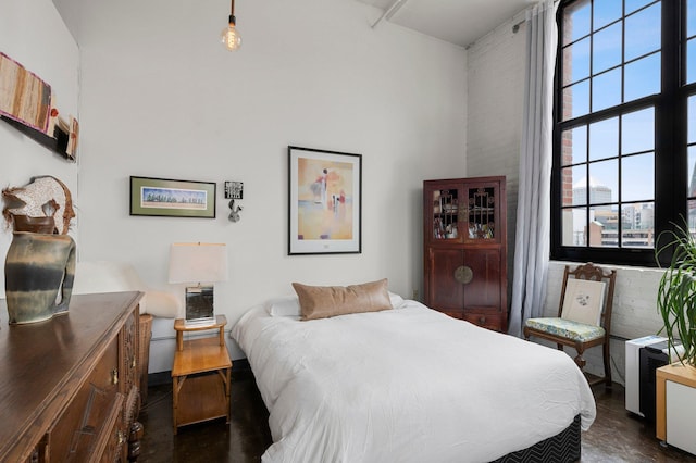 bedroom featuring dark wood-type flooring and multiple windows