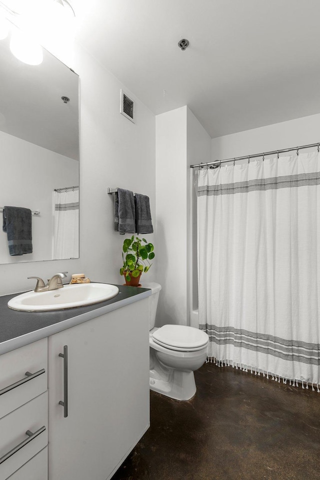 bathroom with vanity, toilet, concrete flooring, and a shower with curtain