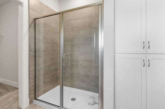 bathroom featuring a shower with shower door