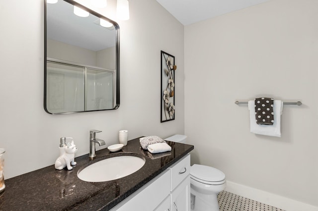 bathroom featuring walk in shower, vanity, and toilet