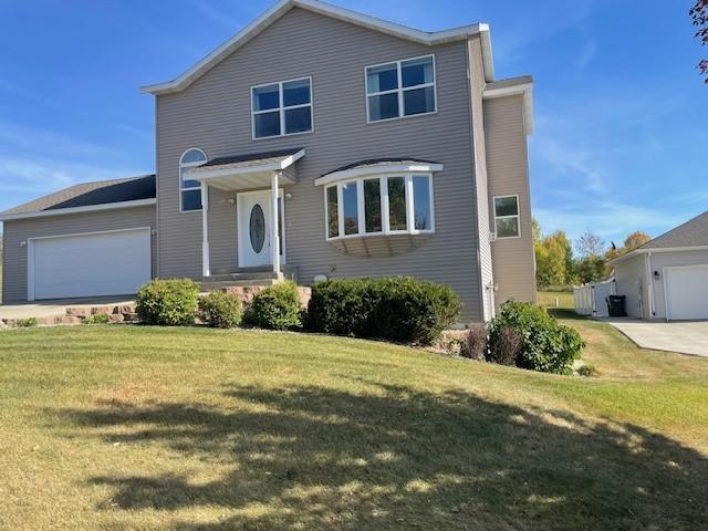 view of front property featuring a garage and a front yard