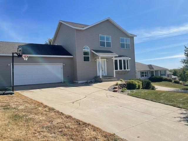 view of property with a garage and a front yard