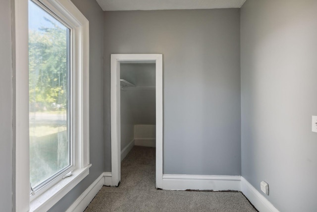 carpeted empty room with baseboards