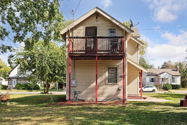 rear view of house featuring a yard