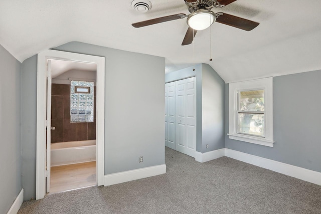 bonus room featuring carpet, vaulted ceiling, baseboards, and ceiling fan