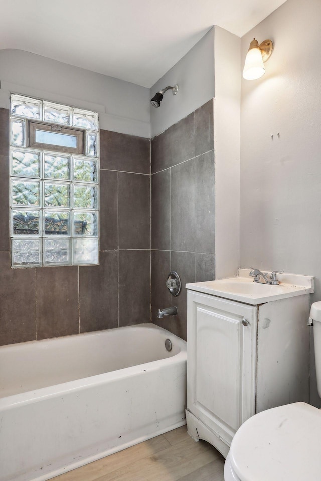 full bathroom featuring vanity, shower / bathing tub combination, wood finished floors, and toilet