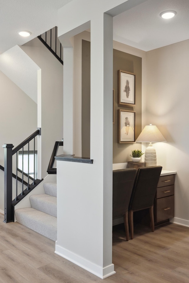 stairs featuring hardwood / wood-style flooring