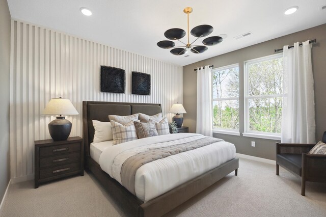 carpeted bedroom featuring an inviting chandelier