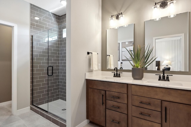 bathroom featuring vanity, a shower with shower door, and tile patterned floors