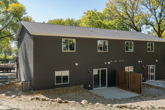 rear view of house featuring a patio and central AC