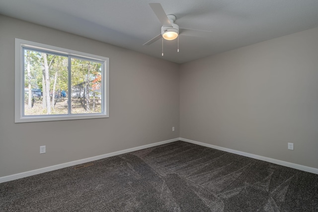 carpeted spare room with a wealth of natural light and ceiling fan