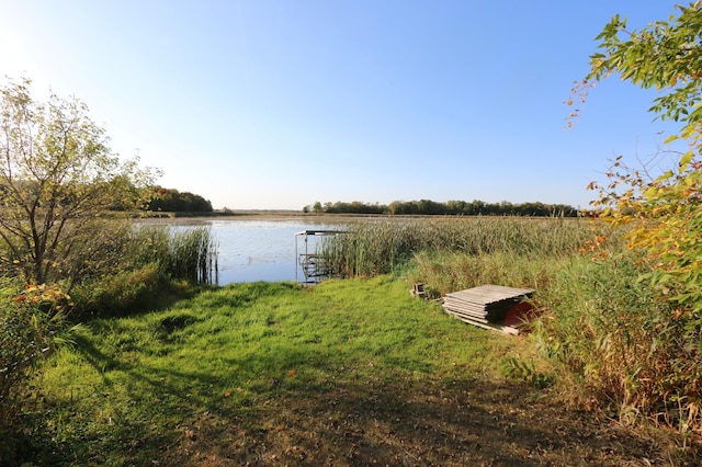 exterior space featuring a water view and a dock