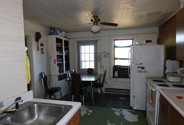 kitchen with white appliances, sink, ceiling fan, and dark tile patterned floors