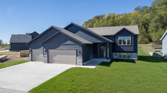 view of front facade featuring a trampoline, a garage, and a front lawn