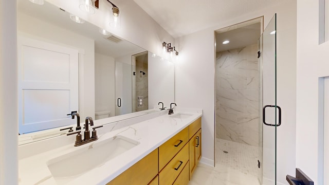 bathroom featuring walk in shower, vanity, and toilet