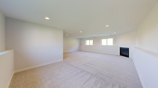 interior space featuring a large fireplace and light colored carpet