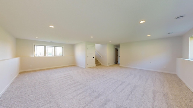 basement featuring light carpet