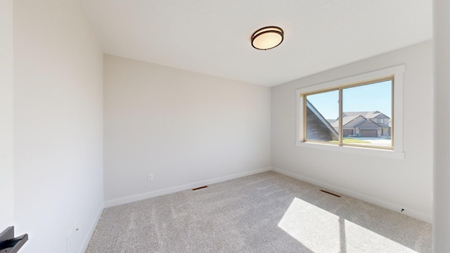 unfurnished room with light carpet