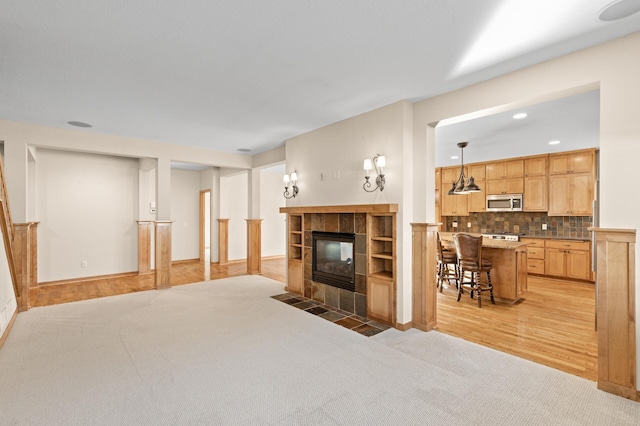 living room with light hardwood / wood-style floors and a fireplace