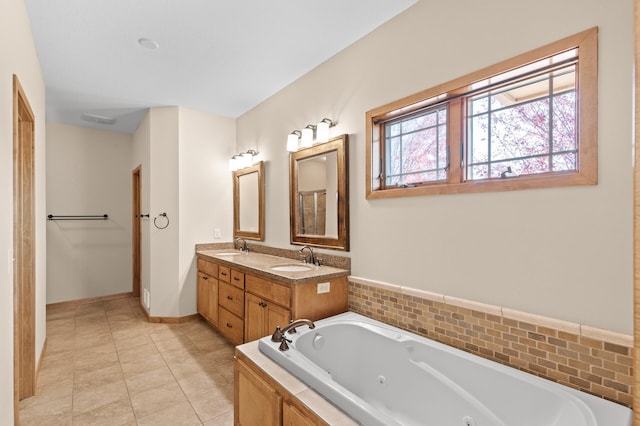 bathroom with vanity, tile patterned floors, and a bath