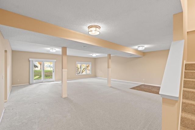 basement featuring carpet flooring and a textured ceiling