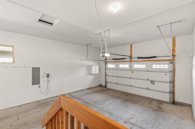 garage with electric panel and a garage door opener