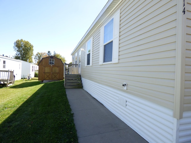 view of yard featuring a storage shed and an outbuilding