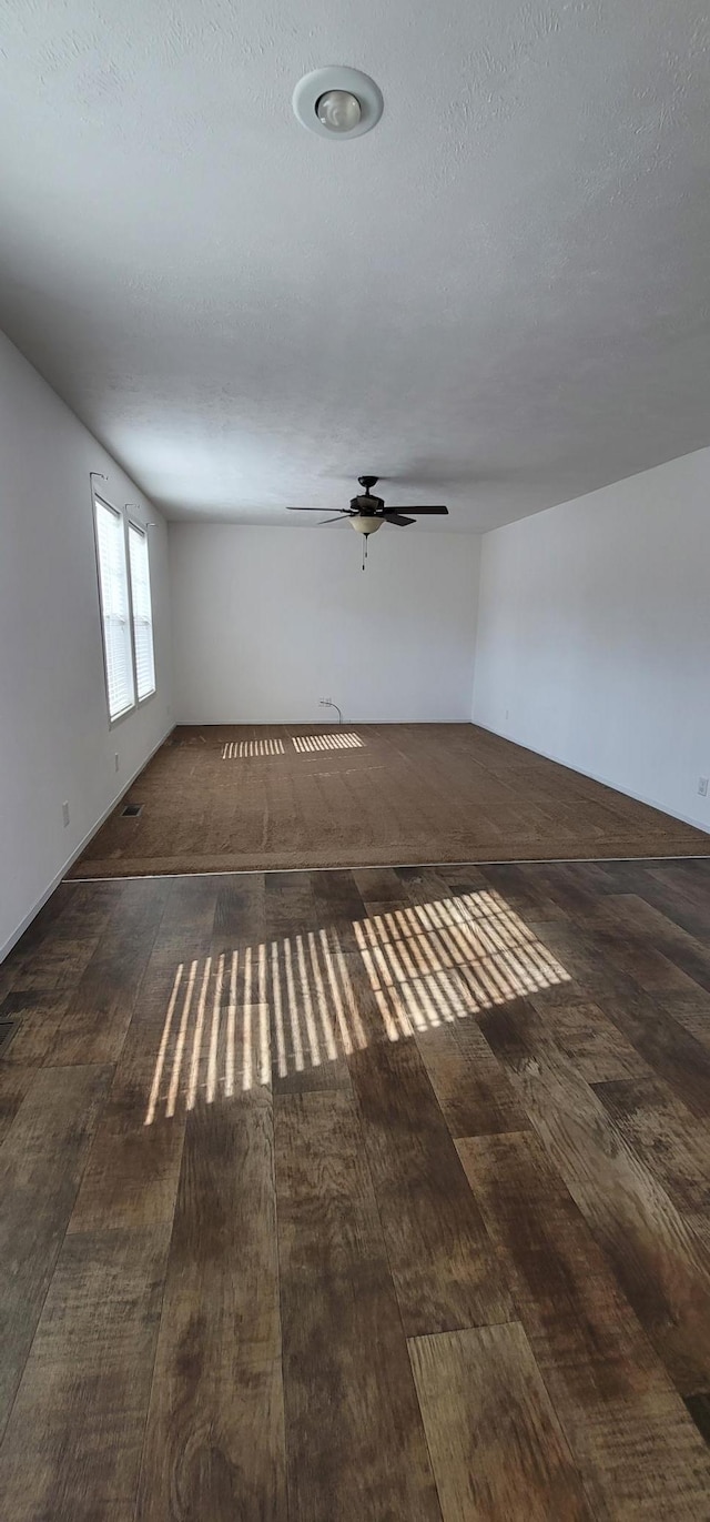 spare room featuring a textured ceiling, hardwood / wood-style floors, and a ceiling fan