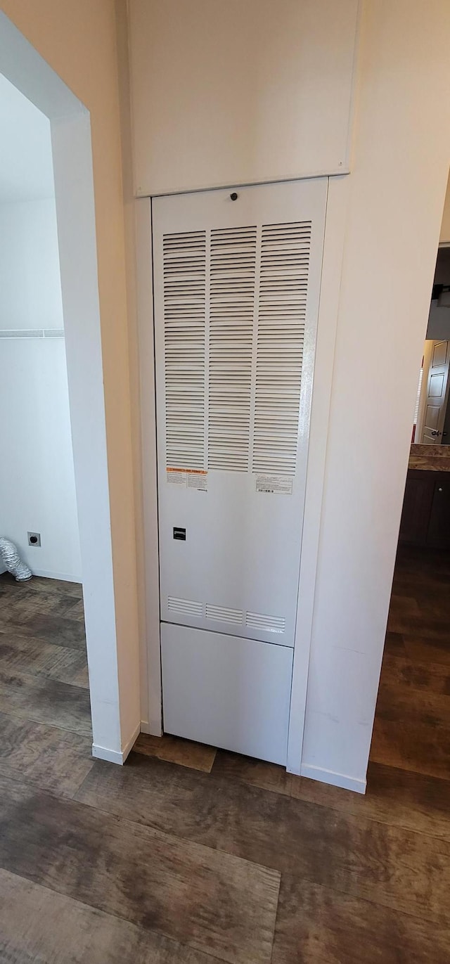 room details featuring a heating unit, baseboards, and wood finished floors