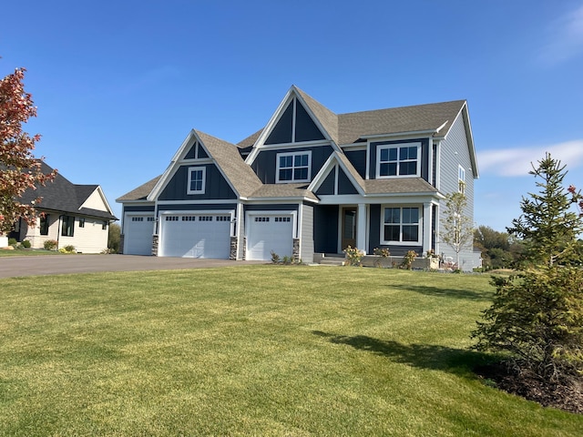 view of front of house featuring a front yard and a garage