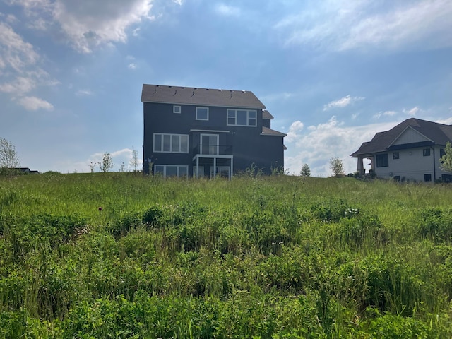 rear view of house featuring a rural view