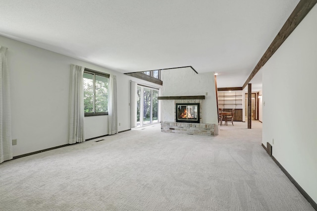 unfurnished living room with a fireplace and light carpet