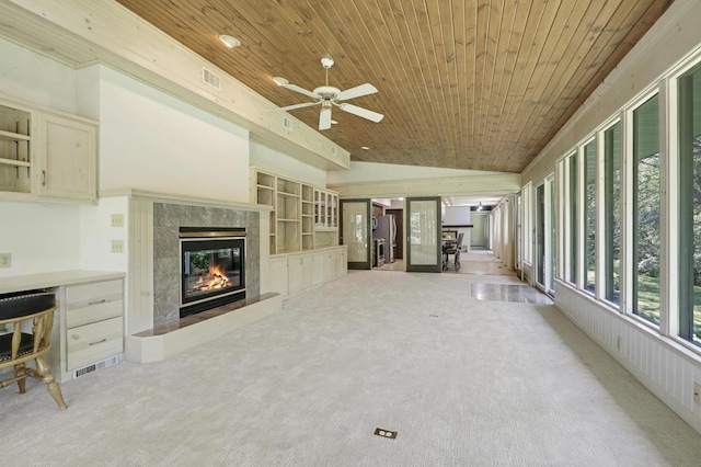 unfurnished living room featuring light carpet, vaulted ceiling, ceiling fan, and wooden ceiling