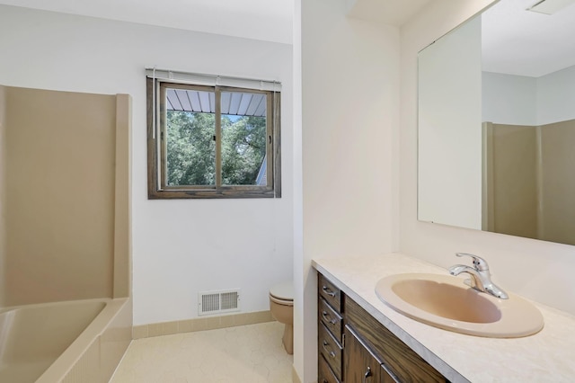 bathroom with vanity, tile patterned floors, a bathtub, and toilet