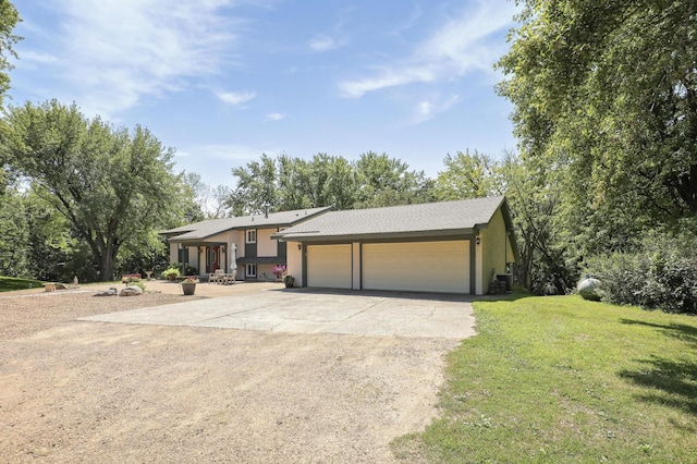 ranch-style house featuring a front yard and a garage