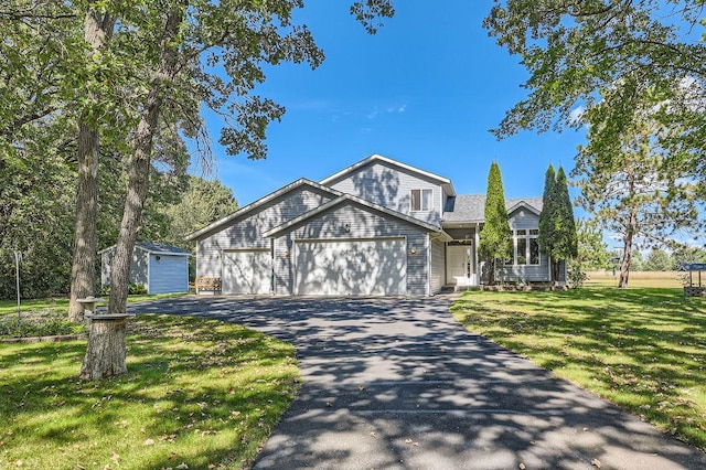 view of front of house featuring a garage and a front lawn