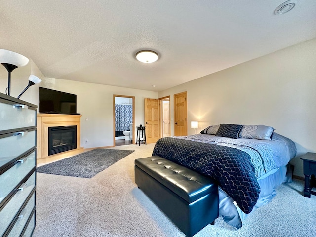 bedroom with carpet floors and a textured ceiling