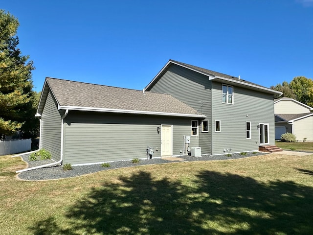 back of house featuring a yard and cooling unit