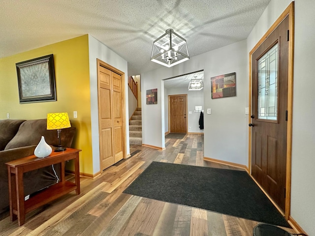 foyer featuring a chandelier, hardwood / wood-style floors, and a textured ceiling