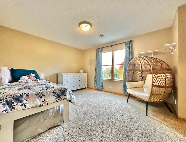 bedroom featuring carpet flooring and a textured ceiling