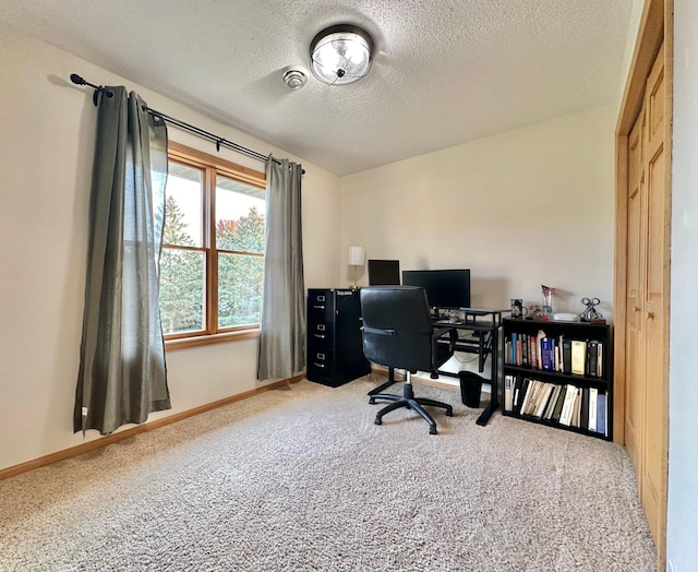 carpeted home office with a textured ceiling