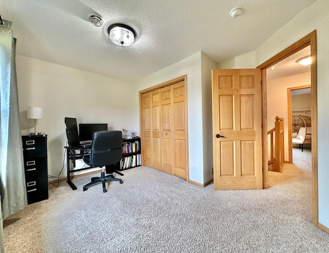 office featuring light colored carpet and a textured ceiling