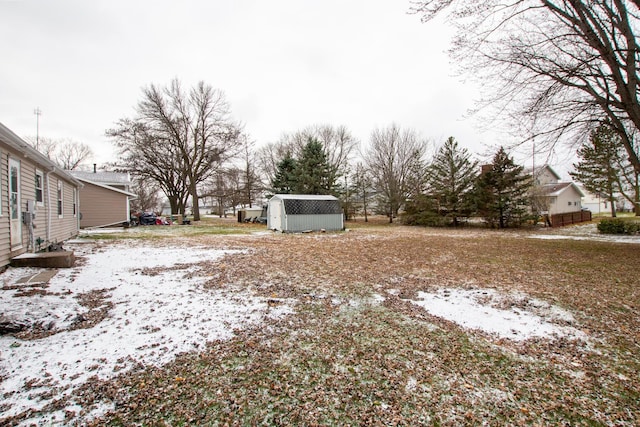 snowy yard with a shed