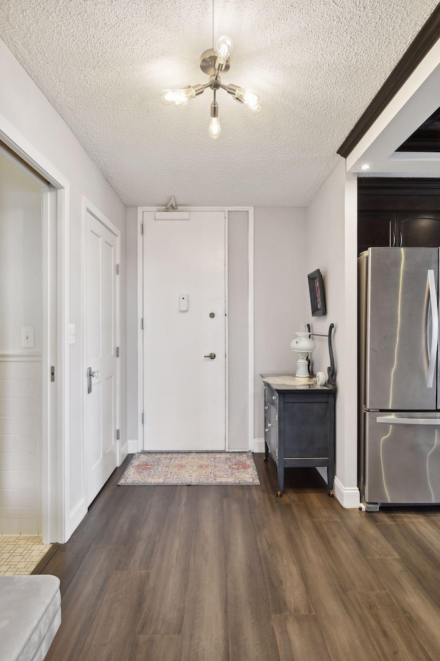 entryway featuring dark hardwood / wood-style flooring and a textured ceiling