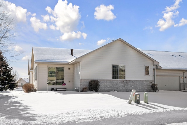 view of front facade with brick siding and an attached garage