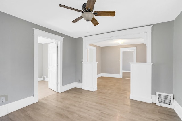 empty room with ceiling fan and light hardwood / wood-style floors