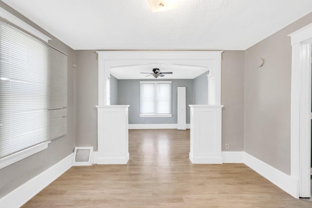 spare room with light hardwood / wood-style floors and ceiling fan