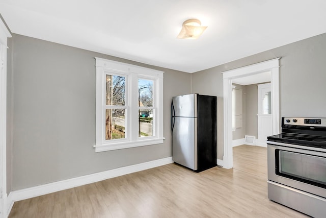 kitchen featuring light hardwood / wood-style floors and appliances with stainless steel finishes